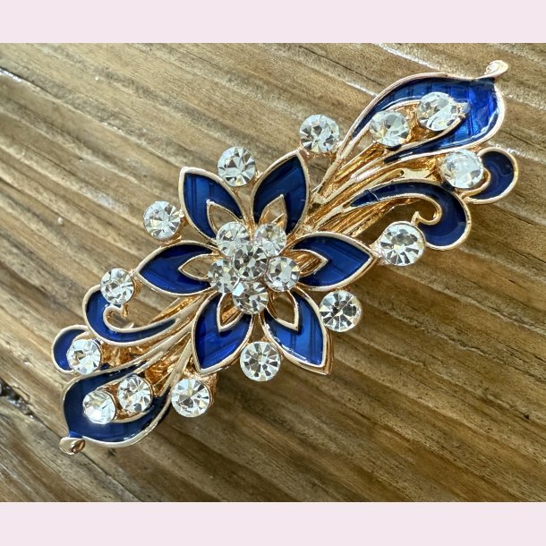 Patentspnde med smuk bl blomst og rhinesten.