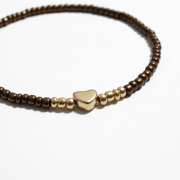 Brunt elastikarmb�nd med guldfarvet hjerte